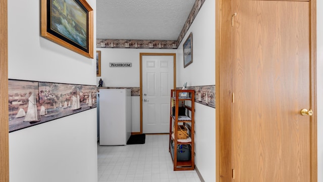 hallway featuring a textured ceiling