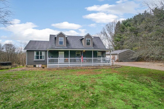 cape cod-style house featuring covered porch and a front yard