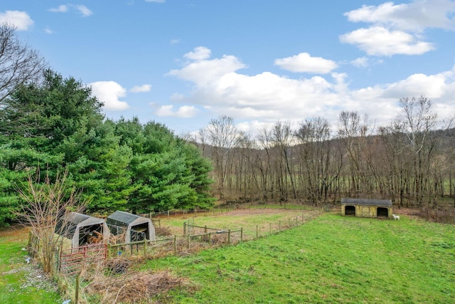 view of yard with an outbuilding and a rural view