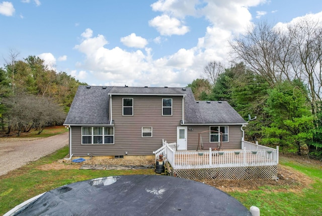 rear view of property featuring a wooden deck