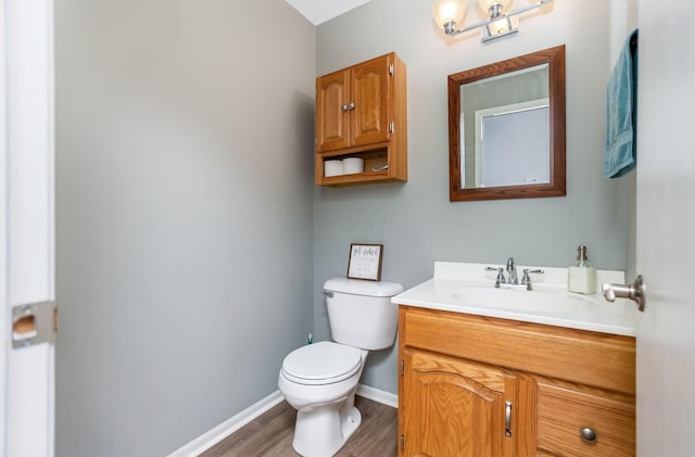 bathroom featuring hardwood / wood-style flooring, vanity, and toilet