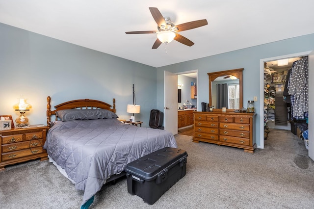 bedroom with carpet, ceiling fan, and ensuite bath