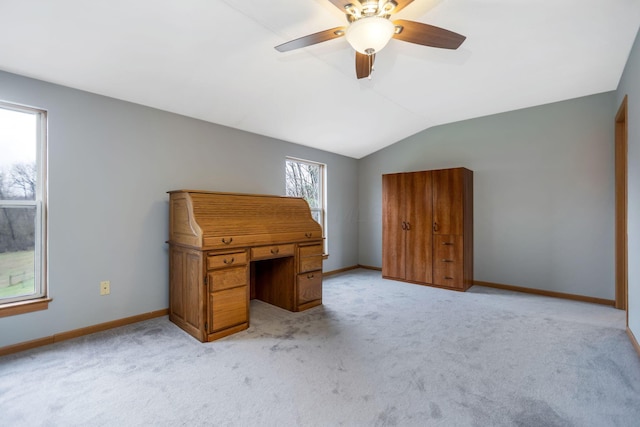 unfurnished office featuring light colored carpet, ceiling fan, and lofted ceiling