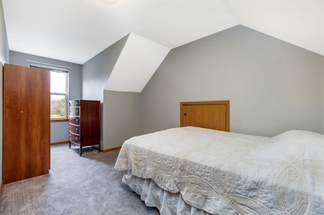 bedroom with light carpet and vaulted ceiling