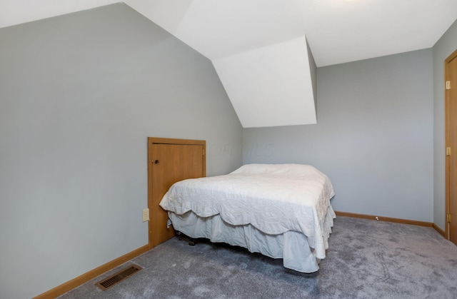 carpeted bedroom featuring lofted ceiling