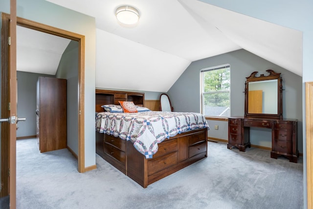 bedroom featuring light carpet and lofted ceiling