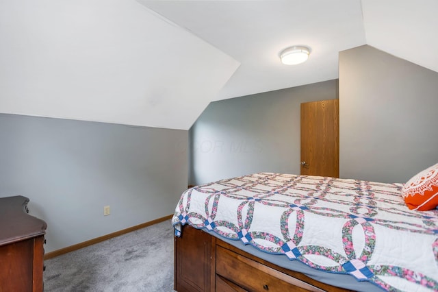 carpeted bedroom featuring vaulted ceiling