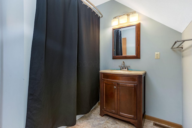 bathroom with vanity and vaulted ceiling