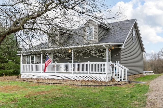 cape cod home featuring covered porch and a front yard