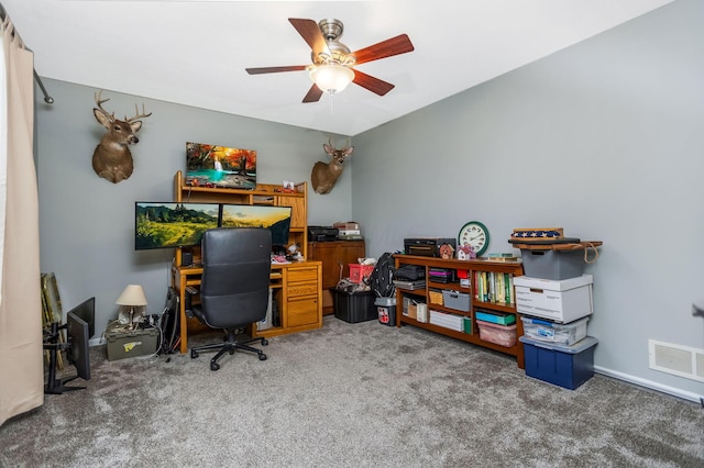 carpeted office space with ceiling fan