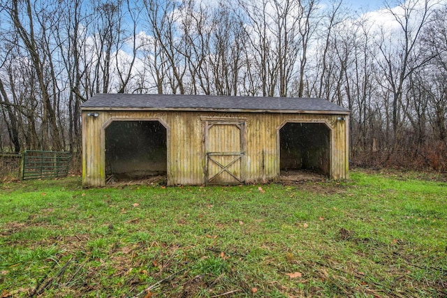 view of outbuilding featuring a yard