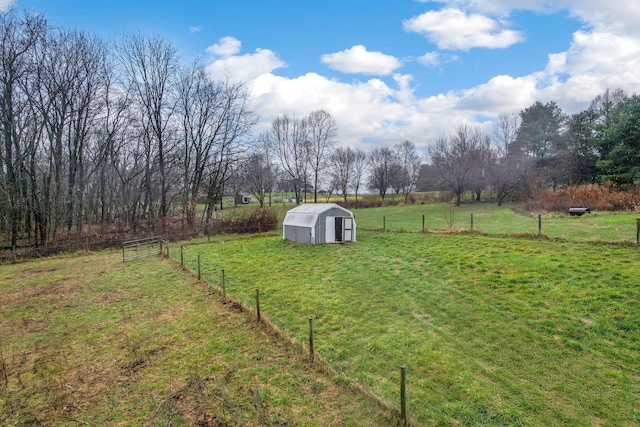 view of yard with a rural view and an outdoor structure