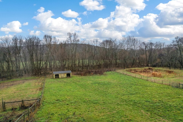 view of yard with a rural view and an outdoor structure