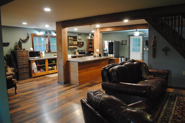 living room with ceiling fan and hardwood / wood-style flooring