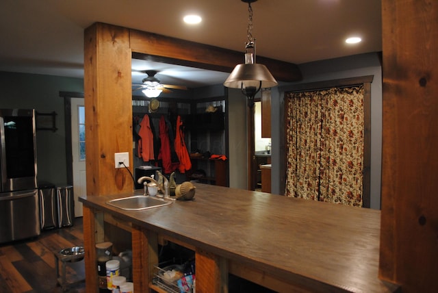 kitchen featuring stainless steel refrigerator, ceiling fan, sink, and dark wood-type flooring