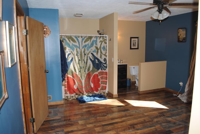 bathroom with curtained shower, ceiling fan, toilet, and hardwood / wood-style flooring