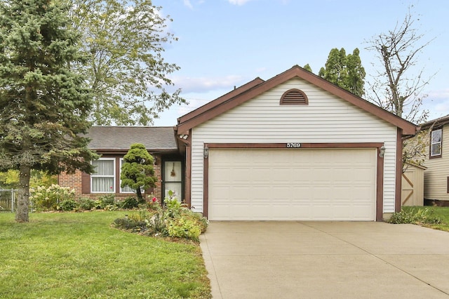 single story home featuring a garage and a front yard