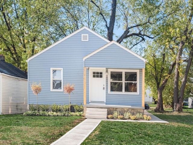 bungalow-style home featuring a front lawn