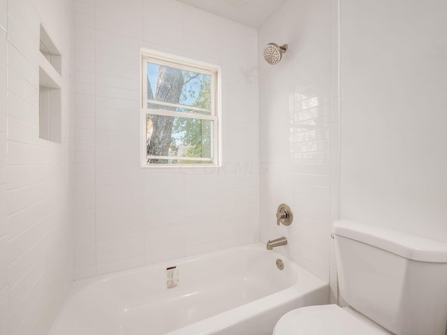 bathroom with tiled shower / bath and toilet