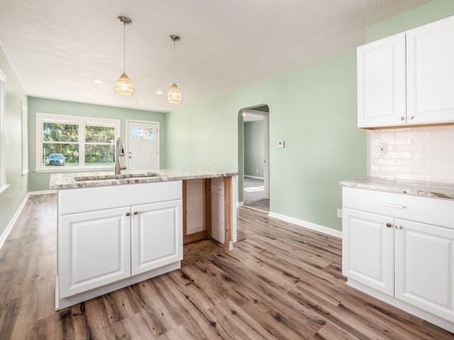 kitchen featuring white cabinets and light hardwood / wood-style floors