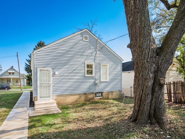 rear view of house with a yard