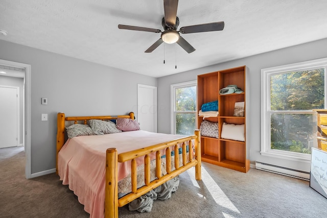 bedroom with baseboard heating, ceiling fan, carpet, and a textured ceiling