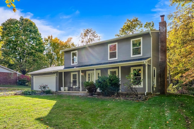 view of front of house featuring covered porch, a front yard, and a garage