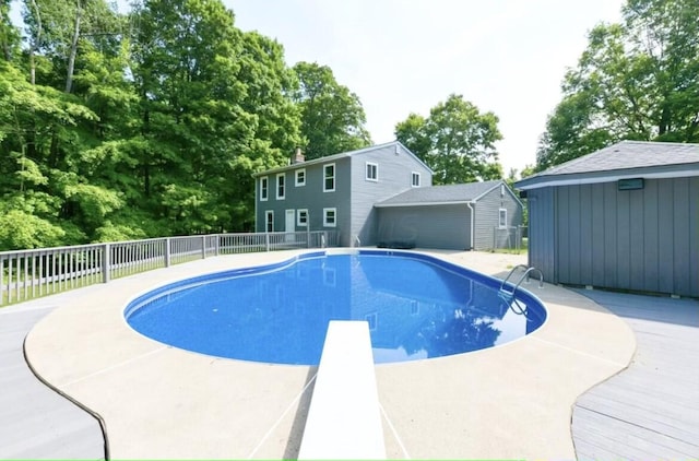 view of pool featuring a patio and a diving board