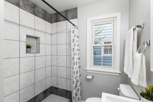 bathroom featuring a shower with curtain and toilet