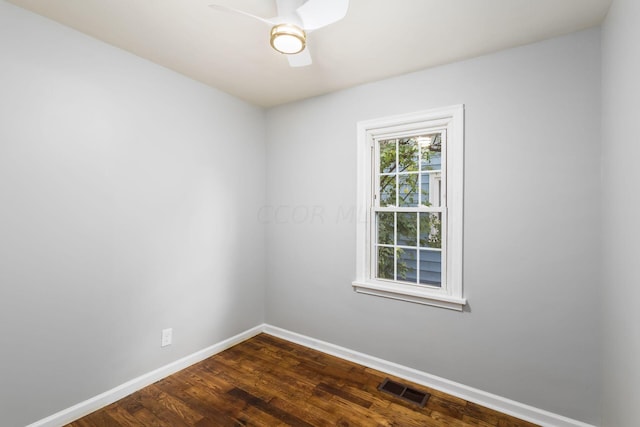 empty room featuring ceiling fan and dark wood-type flooring