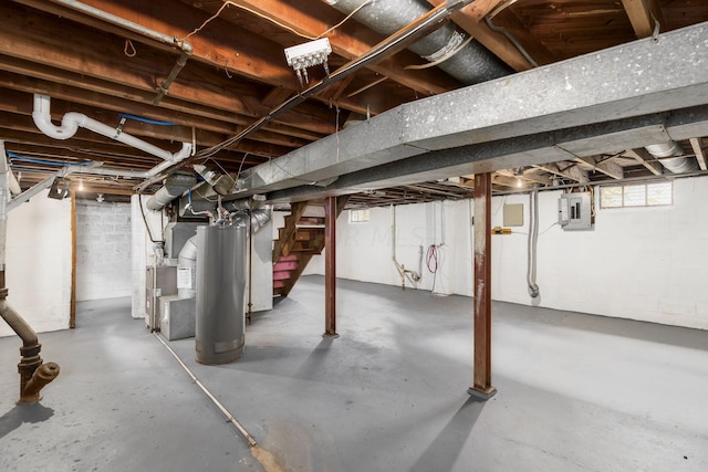 basement with electric panel, water heater, and heating unit