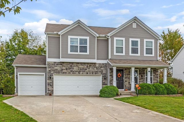 view of front of house featuring a front yard and a garage