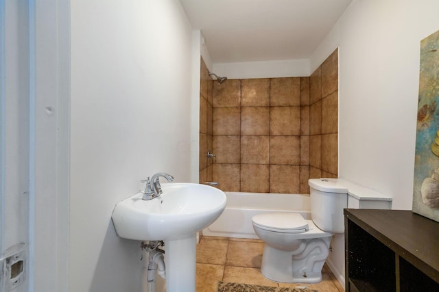 bathroom featuring tiled shower / bath combo and toilet