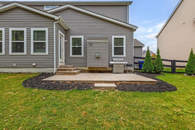 rear view of house with a lawn and a patio