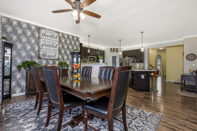 dining room with ceiling fan, dark hardwood / wood-style floors, and ornamental molding