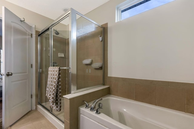 bathroom featuring tile patterned flooring and shower with separate bathtub