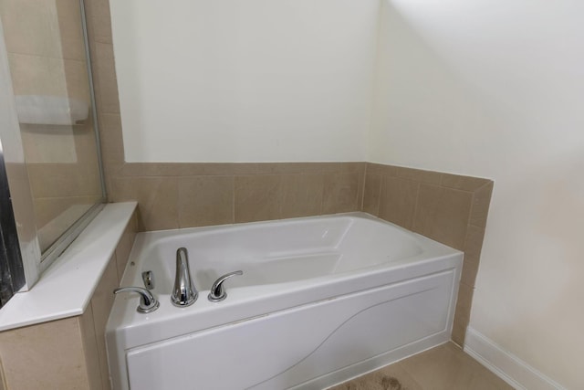 bathroom featuring tile patterned floors and a tub