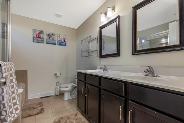 bathroom with tile patterned flooring, vanity, and toilet