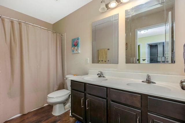 bathroom with a shower with shower curtain, wood-type flooring, vanity, and toilet