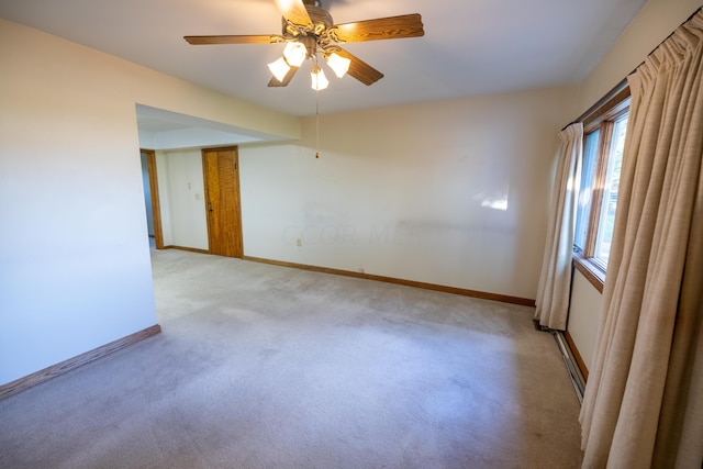 unfurnished room featuring ceiling fan and light carpet