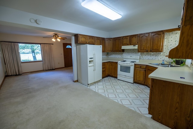 kitchen featuring white appliances, ceiling fan, and sink