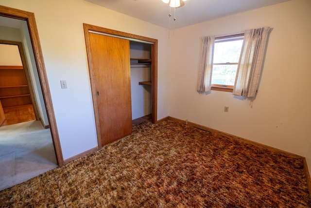 unfurnished bedroom featuring carpet floors and a closet