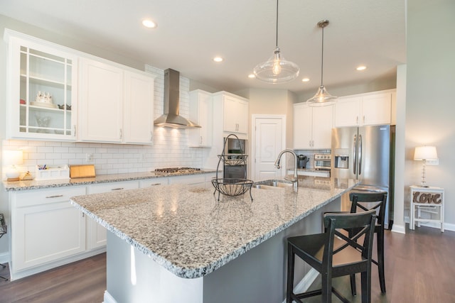 11996 Ficus Field Way, Plain City, OH 43064 - kitchen featuring wall chimney range hood, white cabinets, dark wood-style flooring, appliances with stainless steel finishes, and backsplash