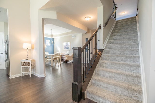 11996 Ficus Field Way, Plain City, OH 43064 - stairs with wood finished floors, a tray ceiling, and ornamental molding
