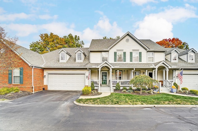 view of front of house featuring a porch and a garage