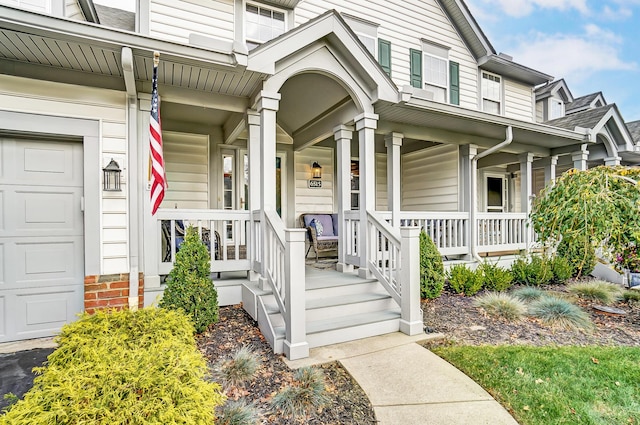 view of exterior entry with a porch