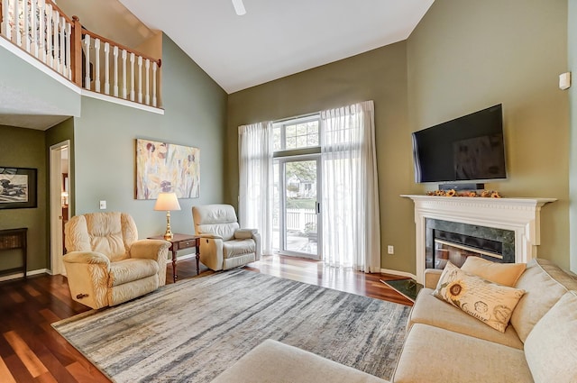 living room featuring high vaulted ceiling and dark wood-type flooring