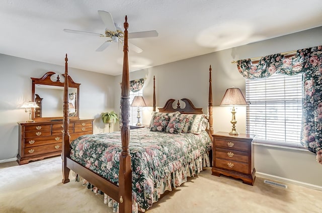 bedroom featuring ceiling fan and light carpet