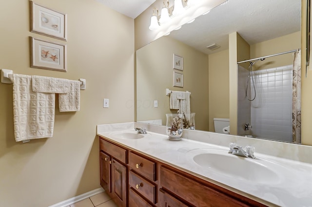 bathroom featuring tile patterned floors, vanity, toilet, and a textured ceiling