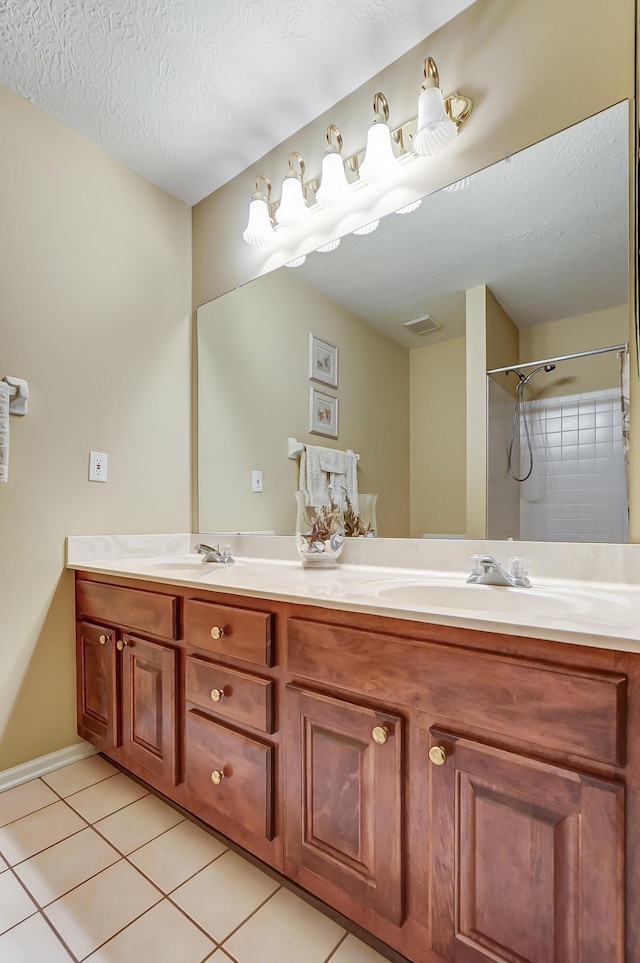 bathroom featuring vanity, a textured ceiling, and tile patterned floors